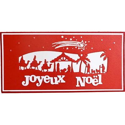 Carte de Noël artisanale avec crèche en découpe de papier sur fond rouge